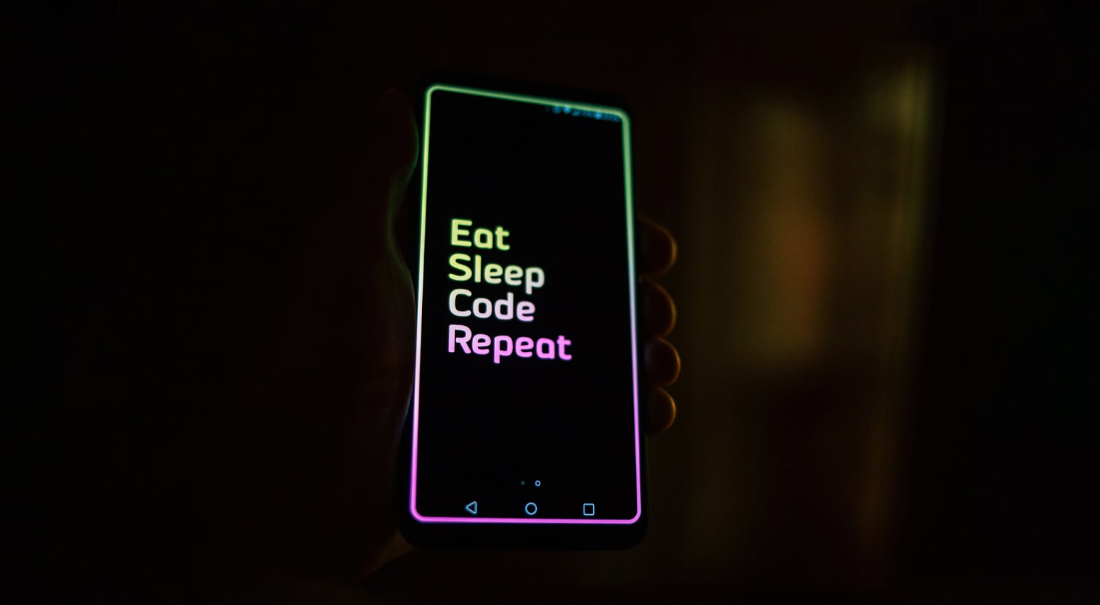 Mobile phone with 'Eat, Sleep, Code, Repeat' message on it